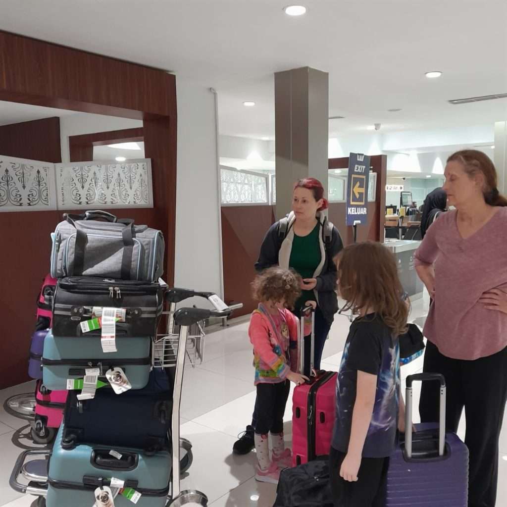 Ferault family arriving at Jakarta airport from the USA with pet travel carriers