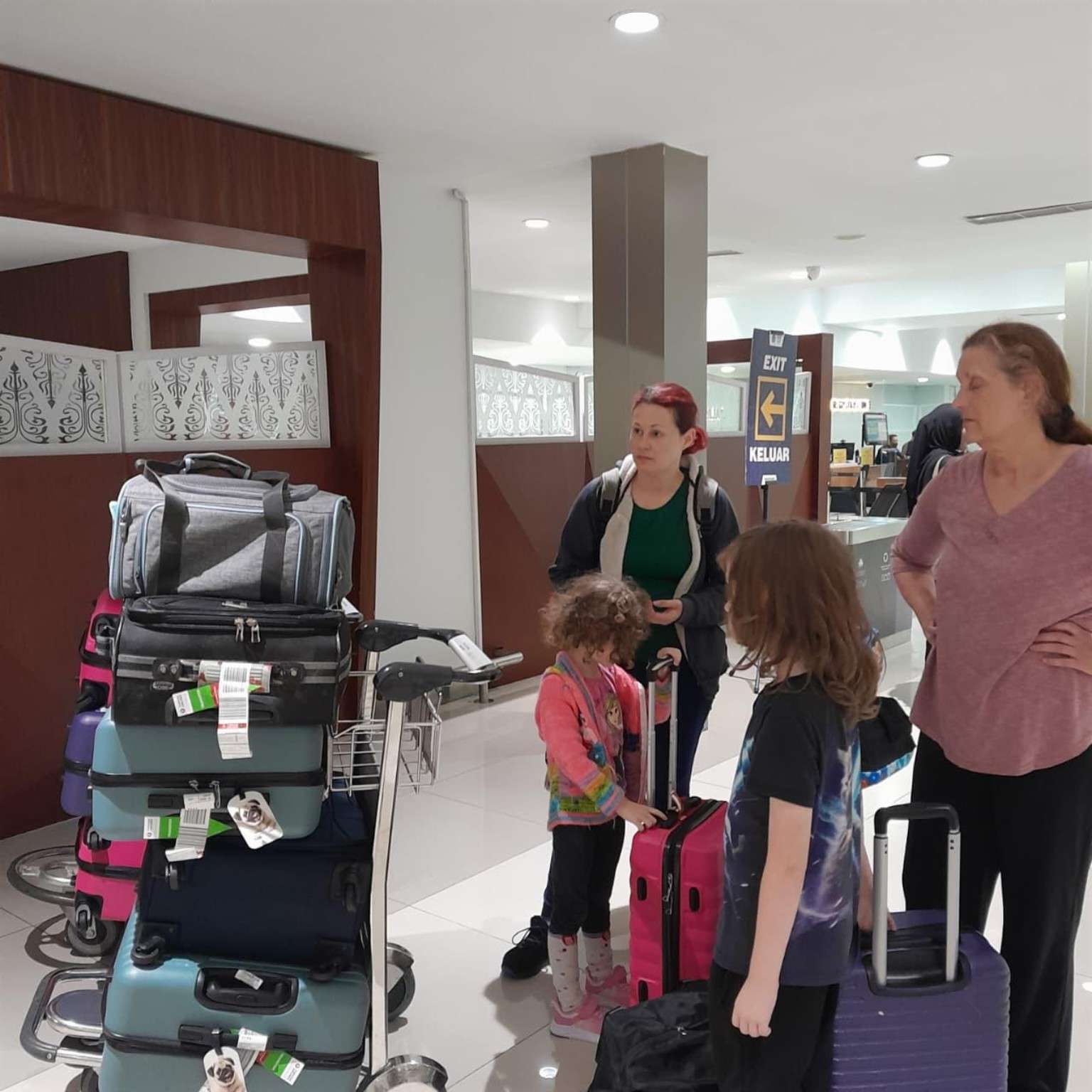 Ferault family arriving at Jakarta airport from the USA with pet travel carriers